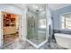 Bright bathroom with glass enclosed shower, soaker tub, and access to walk-in closet at 20361 Enclave Oaks Ct, Cornelius, NC 28031