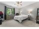 Cozy bedroom with plush carpet, ceiling fan and large window at 20361 Enclave Oaks Ct, Cornelius, NC 28031