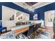 Dining room with a modern chandelier and striking blue accent wall at 20361 Enclave Oaks Ct, Cornelius, NC 28031
