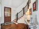 Charming entryway with hardwood floors, wooden door, and staircase featuring decorative iron railings at 20361 Enclave Oaks Ct, Cornelius, NC 28031