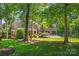 Charming home surrounded by mature trees and verdant greenery with a well-manicured lawn at 20361 Enclave Oaks Ct, Cornelius, NC 28031