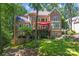 Beautiful home exterior featuring stone accents, multiple levels and lush landscaping at 20361 Enclave Oaks Ct, Cornelius, NC 28031