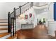 Elegant foyer with hardwood floors, a staircase, and stylish decor at 20361 Enclave Oaks Ct, Cornelius, NC 28031