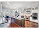 Open kitchen with a center island, stainless steel appliances, and modern lighting at 20361 Enclave Oaks Ct, Cornelius, NC 28031