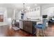 Modern kitchen featuring a dark island, sleek countertops, and stainless steel appliances at 20361 Enclave Oaks Ct, Cornelius, NC 28031
