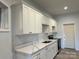 Contemporary kitchen with white cabinets, sleek countertops, and stainless steel appliances, perfect for cooking at 20361 Enclave Oaks Ct, Cornelius, NC 28031