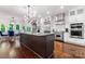 Bright kitchen with a large island, stainless steel appliances, and stylish light fixture at 20361 Enclave Oaks Ct, Cornelius, NC 28031