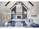 Cozy living room with a striking stone fireplace, wood beams, and ample natural light at 20361 Enclave Oaks Ct, Cornelius, NC 28031