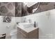 Stylish powder room featuring modern vanity and decorative wallpaper at 20361 Enclave Oaks Ct, Cornelius, NC 28031