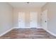 Bedroom featuring neutral walls, wood-look floors, and multiple closets for storage at 1162 Scenic Cir, Shelby, NC 28150