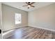 Neutral bedroom with wood-look flooring, ceiling fan, and a window offering ample natural light at 1162 Scenic Cir, Shelby, NC 28150