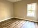 Simple bedroom featuring light walls and wood-look floors at 1162 Scenic Cir, Shelby, NC 28150