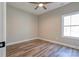 Bright bedroom featuring wood-look laminate flooring and a large window with natural light at 1162 Scenic Cir, Shelby, NC 28150