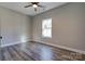 Comfortable bedroom featuring wood-look flooring, ceiling fan, and natural light from a window at 1162 Scenic Cir, Shelby, NC 28150