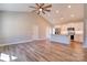 Open-concept living area flows into kitchen with white cabinets and island, featuring wood-look laminate flooring at 1162 Scenic Cir, Shelby, NC 28150