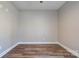 Empty room featuring wood-look laminate flooring, neutral paint, and ample space at 1162 Scenic Cir, Shelby, NC 28150