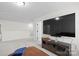 Well-lit bonus room with a wall-mounted TV and ample seating space at 122 W Heart Pine Ln, Statesville, NC 28677