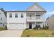 Charming two-story home featuring a welcoming front porch and attached two-car garage at 122 W Heart Pine Ln, Statesville, NC 28677
