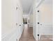Hallway with hardwood floors, white walls, crown molding and entry to other rooms at 122 W Heart Pine Ln, Statesville, NC 28677