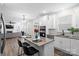 Open kitchen with island, stainless steel appliances, and seamless transition into the living area with a fireplace at 122 W Heart Pine Ln, Statesville, NC 28677