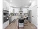 Well-equipped kitchen with white cabinets, stainless steel appliances, and a functional island with barstool seating at 122 W Heart Pine Ln, Statesville, NC 28677