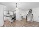Spacious kitchen featuring white cabinets, an island with barstool seating, and access to the staircase and other living spaces at 122 W Heart Pine Ln, Statesville, NC 28677