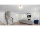 Bright living room with modern fireplace, plush sofa, and open staircase at 122 W Heart Pine Ln, Statesville, NC 28677