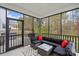Screened porch featuring outdoor seating and views of the backyard and fall foliage at 122 W Heart Pine Ln, Statesville, NC 28677