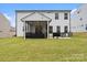 A well-maintained backyard with a screened porch and outdoor seating area, ideal for enjoying the outdoors at 122 W Heart Pine Ln, Statesville, NC 28677