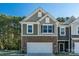 Two-story townhome with brick and siding, two-car garage, and a well-maintained lawn at 278 Harpers Run Ln, Matthews, NC 28104