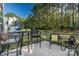 Relaxing patio with table and chairs, overlooking wooded area at 278 Harpers Run Ln, Matthews, NC 28104