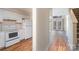 Well-equipped kitchen with white cabinets and wood flooring at 3312 Heathstead Pl, Charlotte, NC 28210