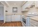 Bright kitchen features white cabinets, laminate countertops, and modern appliances at 3312 Heathstead Pl, Charlotte, NC 28210