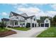 White farmhouse with a large driveway and attached three-car garage at 1325 Ballard Dr, Waxhaw, NC 28173