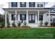 Inviting front porch with black double doors and white columns at 1325 Ballard Dr, Waxhaw, NC 28173