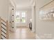 Light-filled hallway with French doors and hardwood floors at 1325 Ballard Dr, Waxhaw, NC 28173