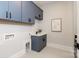 Modern laundry room with gray cabinets and a built-in sink at 1325 Ballard Dr, Waxhaw, NC 28173