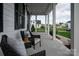 Relaxing front porch with wicker chairs and view of neighborhood at 1325 Ballard Dr, Waxhaw, NC 28173