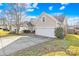 Beige house with a two-car garage and a well-maintained lawn at 136 Kristens Court Dr, Mooresville, NC 28115