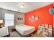 bedroom with orange accent wall and built-in shelving at 1964 Clear Brooke Dr, Kannapolis, NC 28083