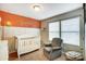 Bedroom featuring a crib, armchair, and calming color scheme at 1964 Clear Brooke Dr, Kannapolis, NC 28083