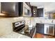 Close-up of kitchen range, microwave, and granite countertop at 1964 Clear Brooke Dr, Kannapolis, NC 28083