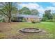 Large backyard with fire pit and mature trees at 206 N Trexler Ave, Rockwell, NC 28138