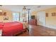 Main bedroom with four-poster bed, hardwood floors, and ceiling fan at 206 N Trexler Ave, Rockwell, NC 28138