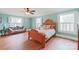 Bedroom with hardwood floors, antique bed, and light teal walls at 206 N Trexler Ave, Rockwell, NC 28138