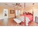 Main bedroom with four-poster bed, hardwood floors, and ceiling fan at 206 N Trexler Ave, Rockwell, NC 28138