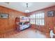 Bedroom with bunk beds, wood paneling, and hardwood floors at 206 N Trexler Ave, Rockwell, NC 28138