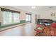 Living room with hardwood floors, large windows, and an antique piano at 206 N Trexler Ave, Rockwell, NC 28138