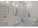 Elegant bathroom with dual vanities, soaking tub, and gold fixtures at 2410 Brantley Rd, Kannapolis, NC 28083