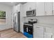 Modern kitchen with stainless steel appliances, white cabinets, and light countertops at 2410 Brantley Rd, Kannapolis, NC 28083